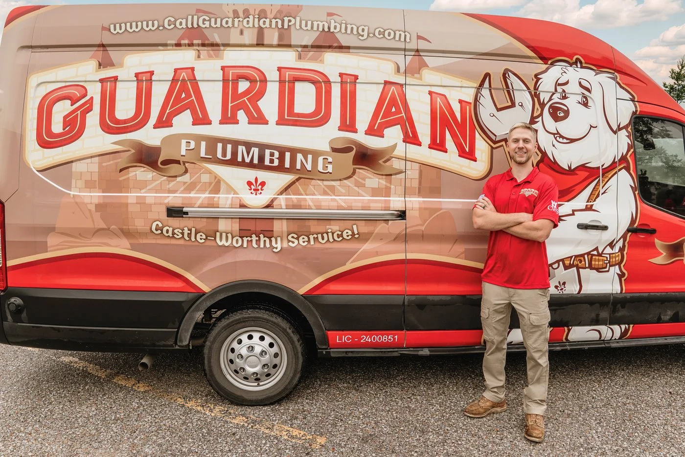 Guardian Plumbing technician standing by a Guardian Plumbing van
